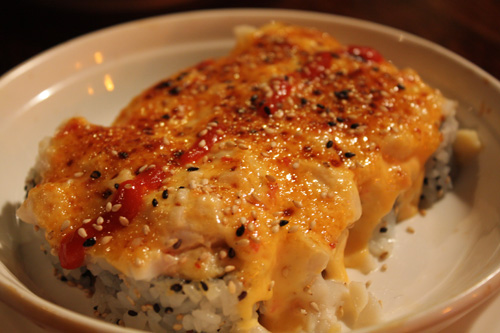 Rock n’Roll: Baked Spicy Scallops Served on top of a California Roll